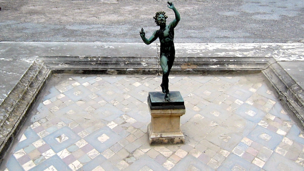Bronze Dancing Faun statue in Pompeii
