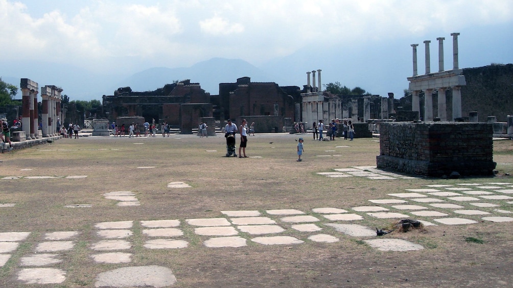 People walking among the ruins of Pompeii
