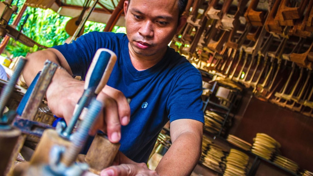 Man making musical instruments in Mandaue