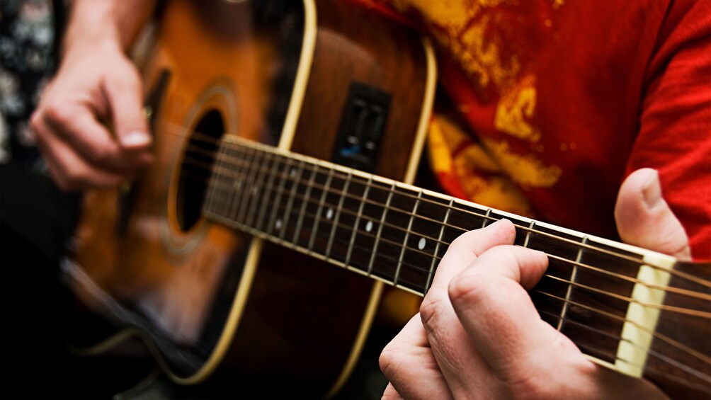 Someone playing the acoustic guitar on a tour of Mandaue