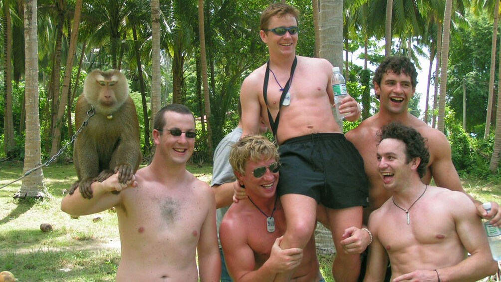 5 guys posing with a monkey in Koh Samui
