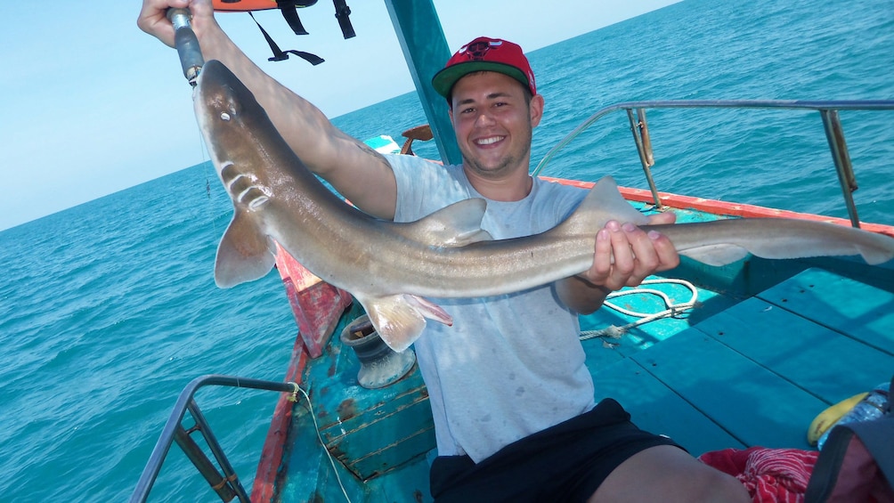 Man holding long fish in Koh Samui