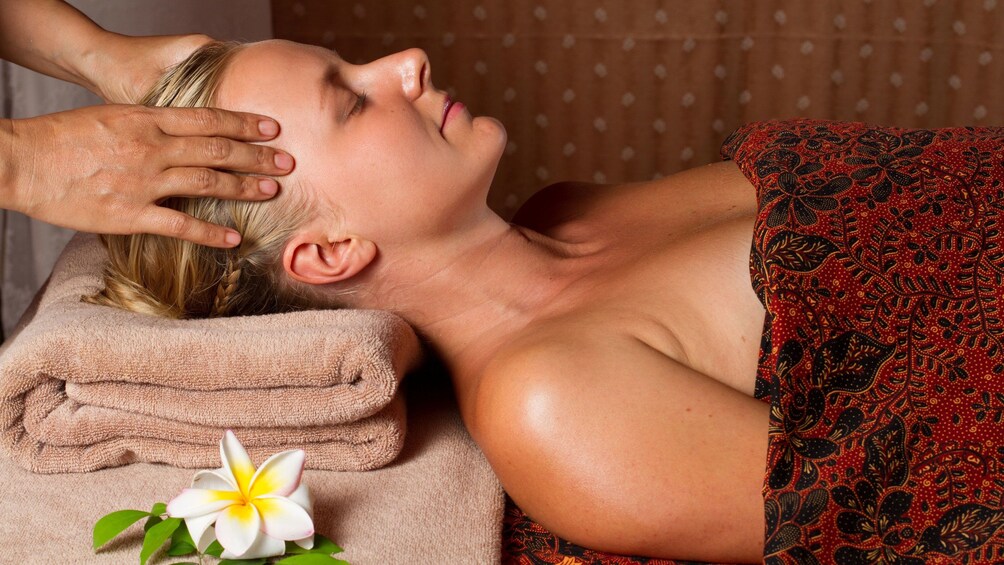 Woman getting head massage in Koh Samui