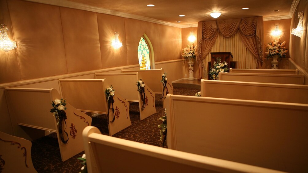 Intimate view inside the storybook wedding chapel with the altar adorned with beautiful flowers