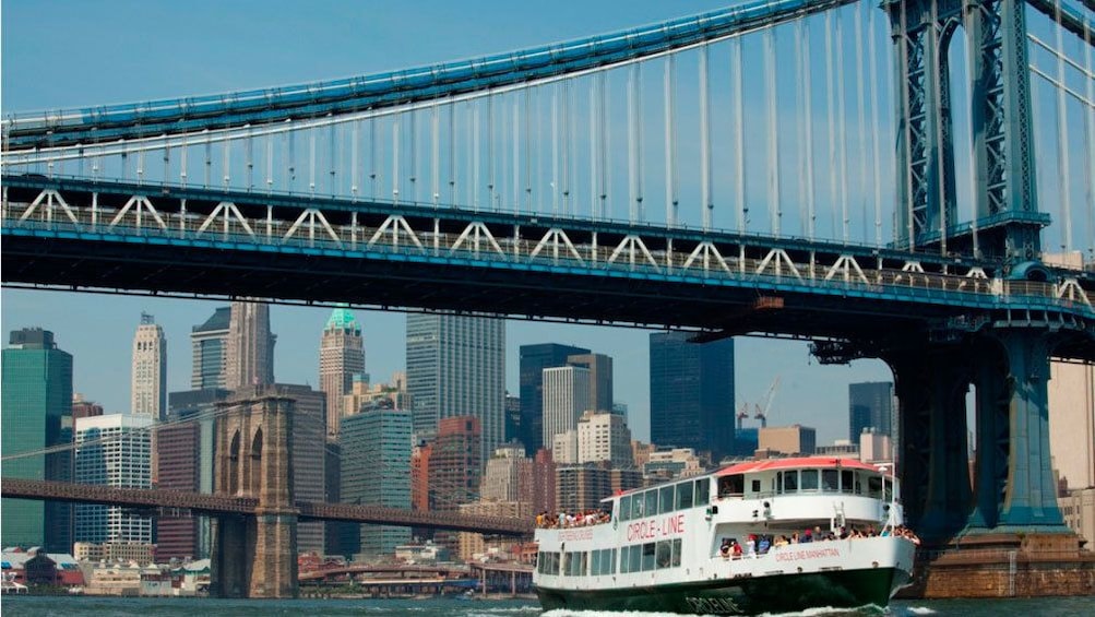 Cruise boat going under the Manhattan Bridge in New York