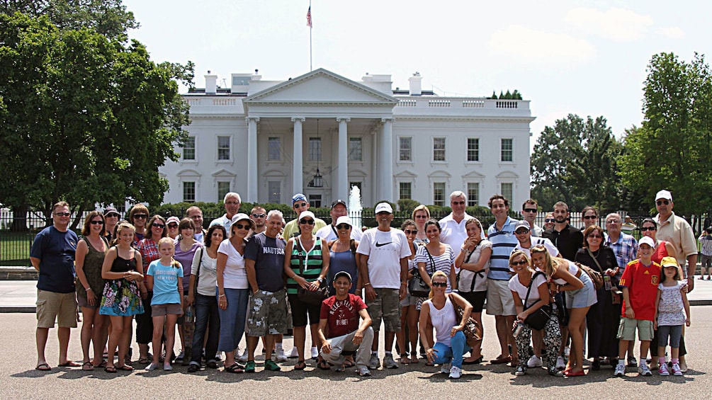 Tour group poses in front of White House