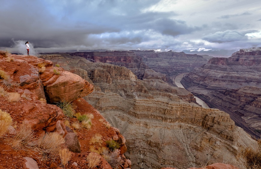 Wide shot of person looking over the Grand Canyon