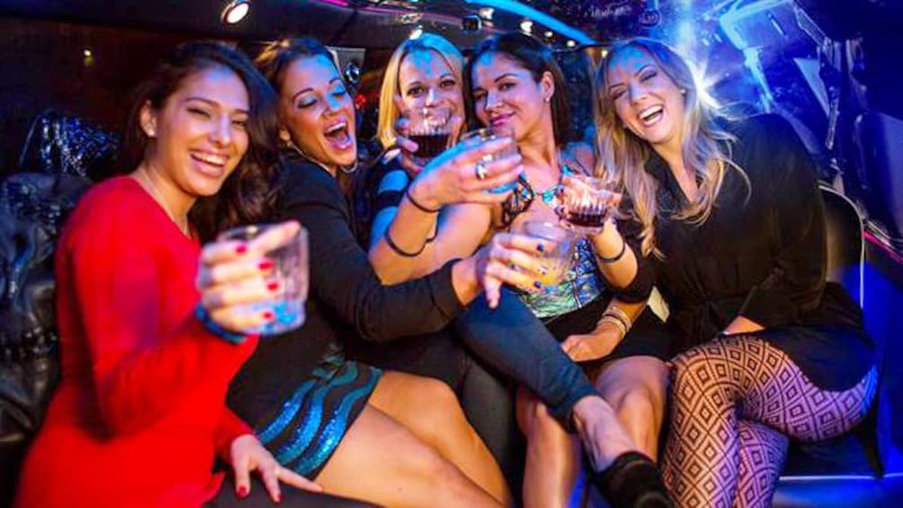 Group of young ladies holding up drinks and laughing inside a club in Las Vegas 