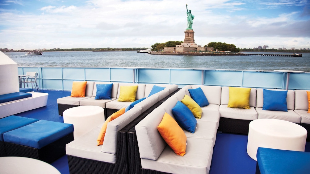 Outdoor seating on cruise boat near the Statue of Liberty in New York