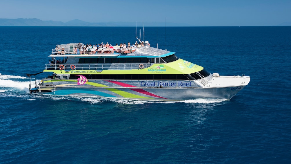 Tour group on catamaran cruise to stunning coral reefs in Cairns