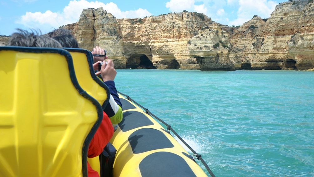 Tour boat passengers taking photos of the Insonia Caves in Algarve