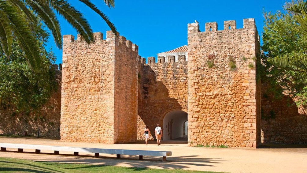 Couple walking into the Silves Castle in Silves