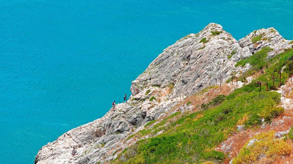 Couple walking along the coastal cliff in Portugal