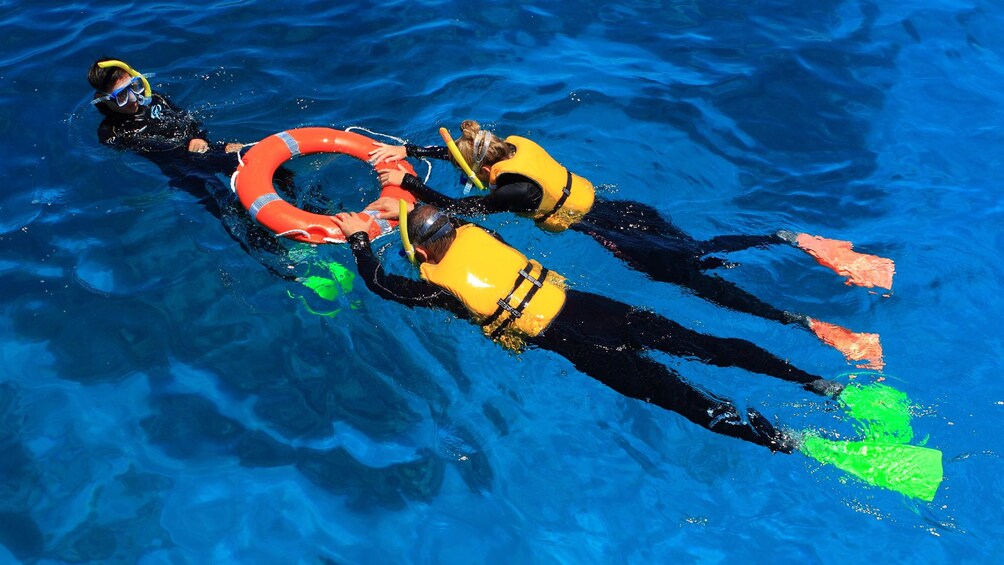 Show item 4 of 8. Couple snorkeling with a guide at Green Island in Australia