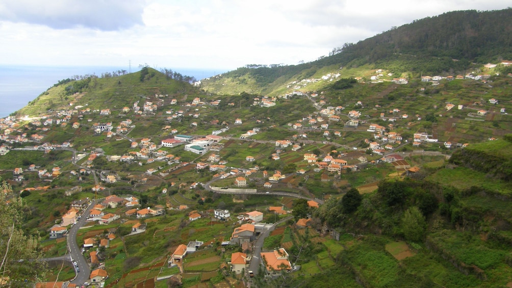 A town nestled into rolling green hills in Madeira
