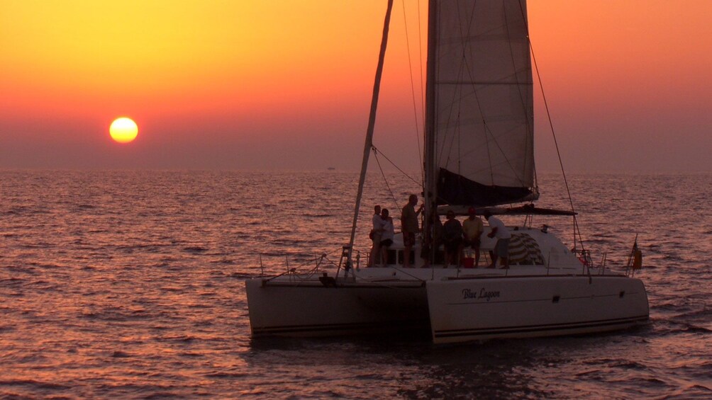 Sailboat at sunset in Santorini