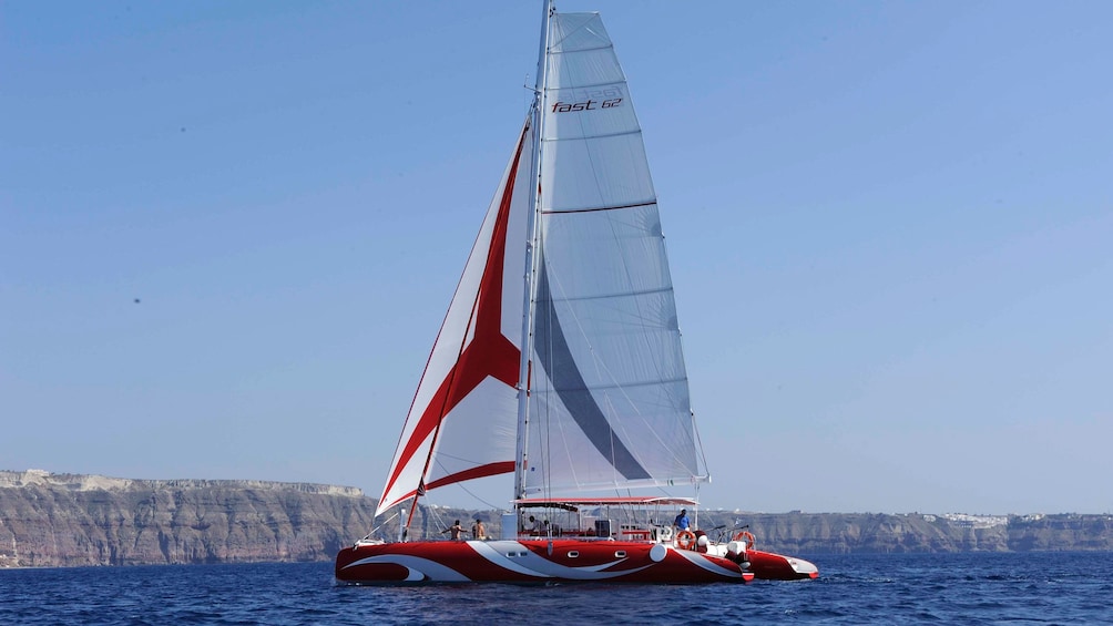 Landscape view of a boat cruising along Santorini  