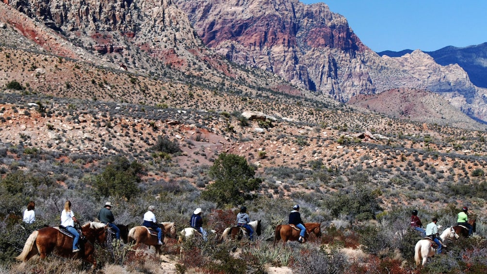 Landscape view of horseback riders venturing into the back country of the Wild West in Las Vegas