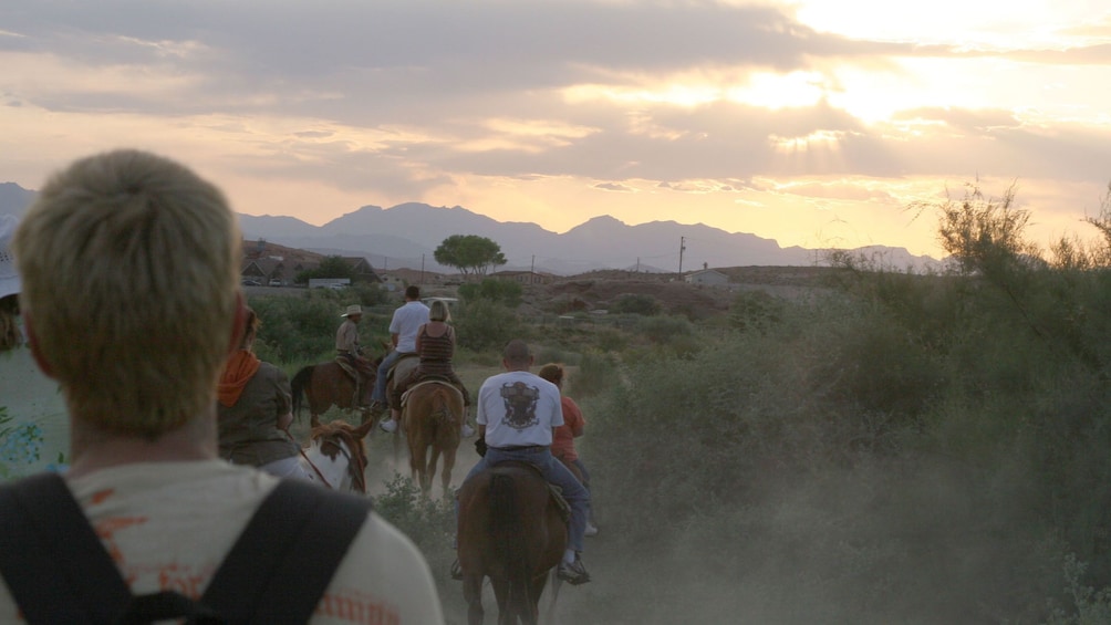 Show item 4 of 5. Group of horseback riders going into the Wild West in Las Vegas