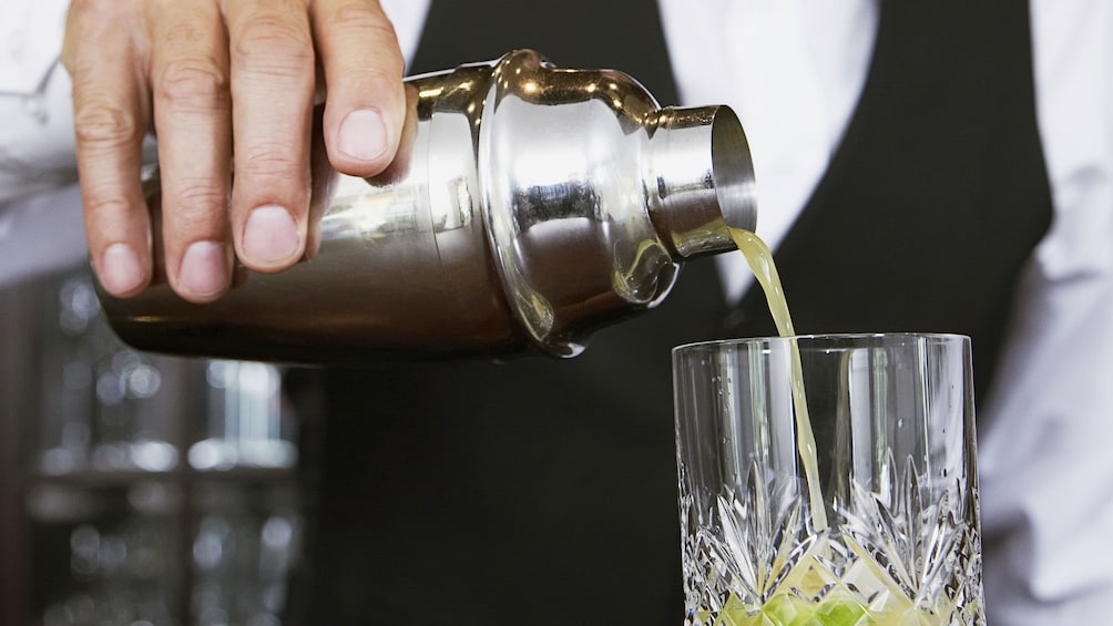 bartender pouring cocktail into glass in New Orleans