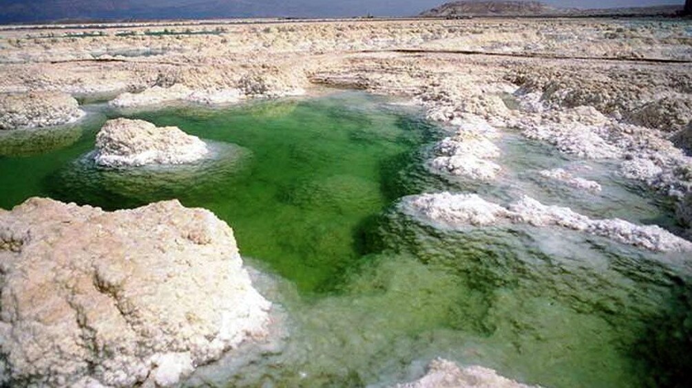 salt covered rock formations in the dead sea
