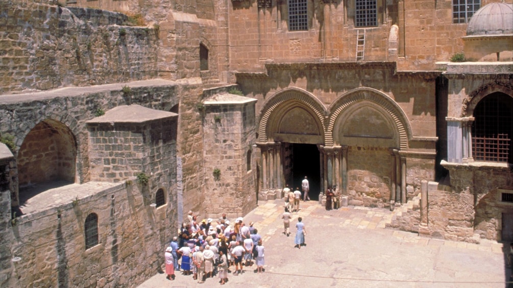 A group of people standing in ancient ruins outside Jerusalem