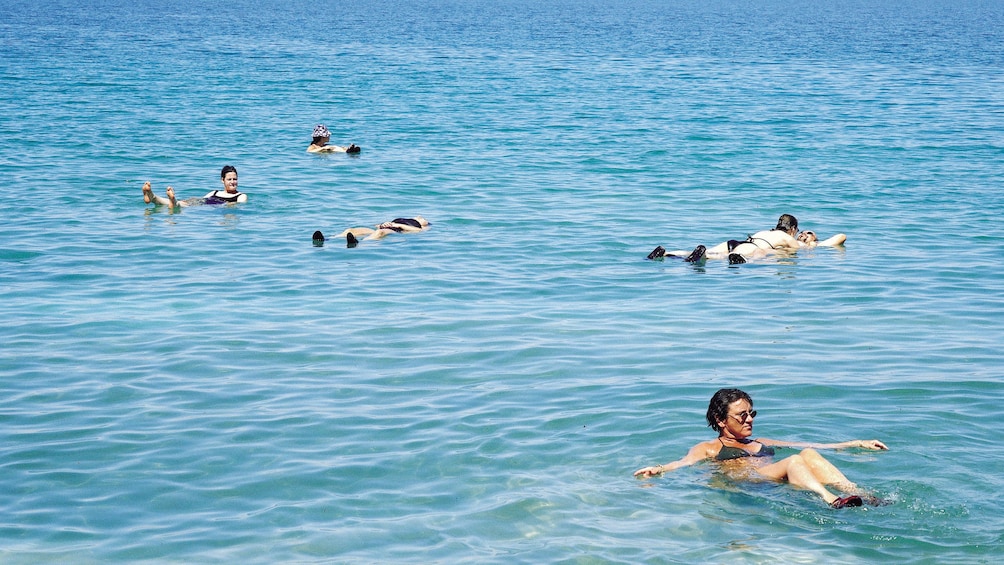 A small group of people floating in the dead sea