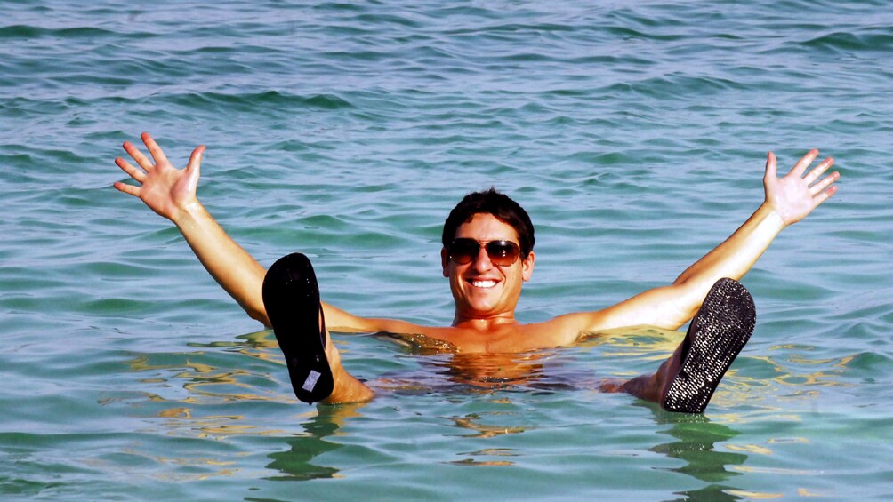 Foto 5 van 6. A man floating in the dead sea
