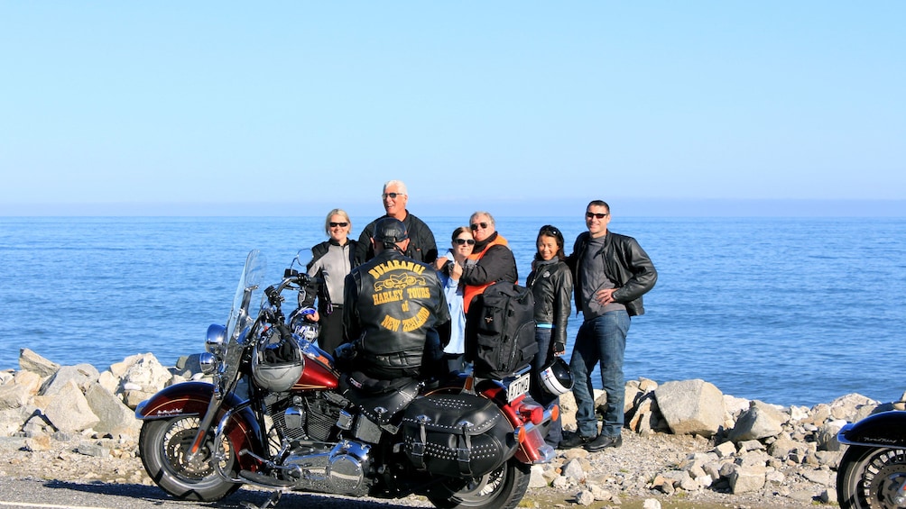 Harley riding group posing for a picture along the coast in Auckland
