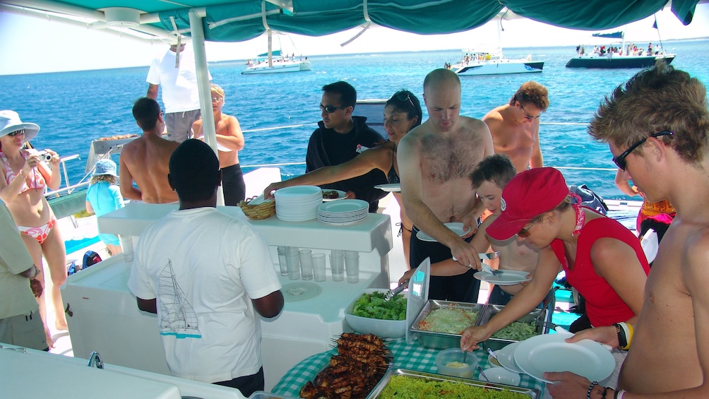 catamaran passengers serving themselves lunch in Mauritius