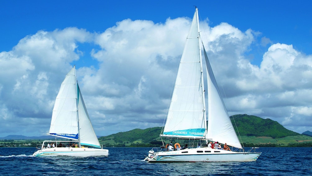 two catamarans coasting along each other in Ile aux Cerfs