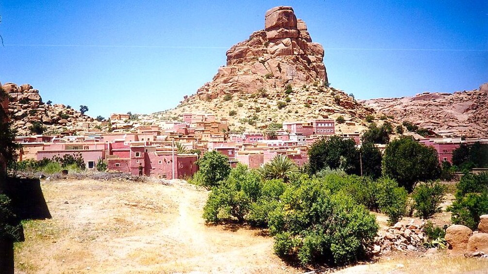 Red rock formations rise above the town of Tafraout
