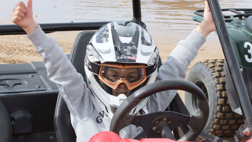 Dune buggy driving kid behind the wheel in Agadir