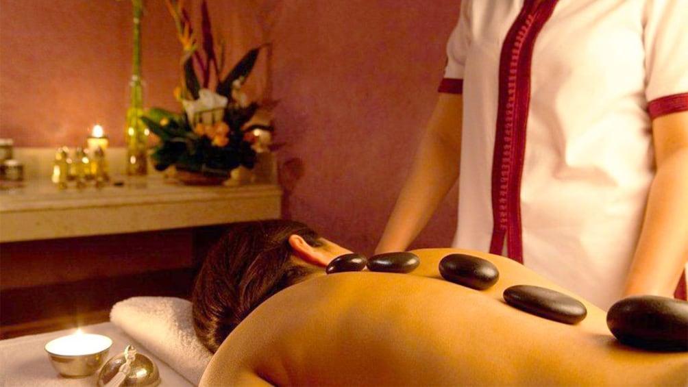 Woman receiving a hot stone massage at a spa in Morocco