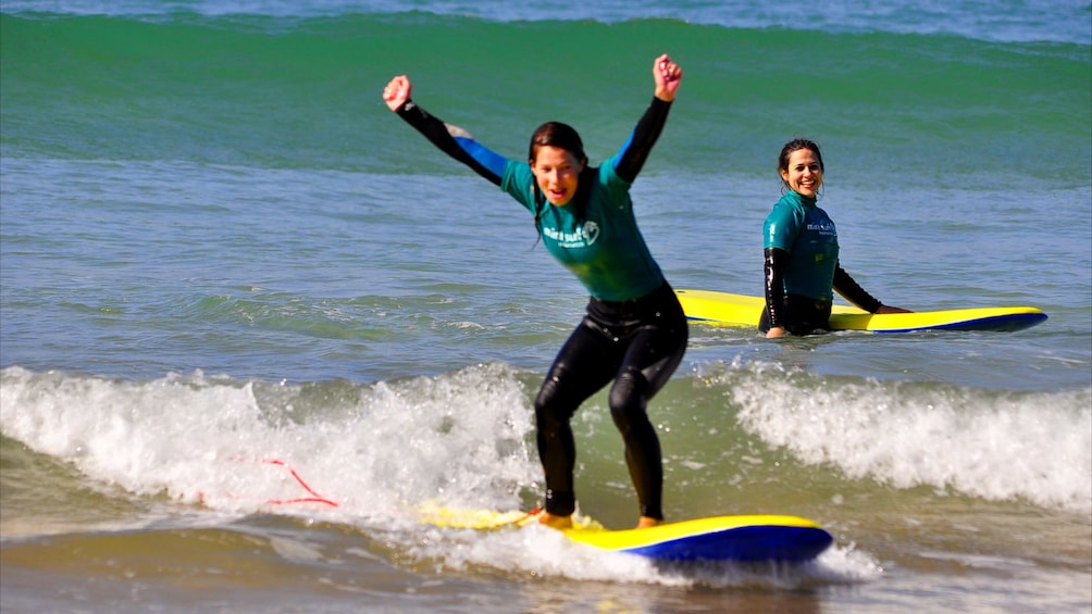 Triumphant woman catching a wave in Agadir