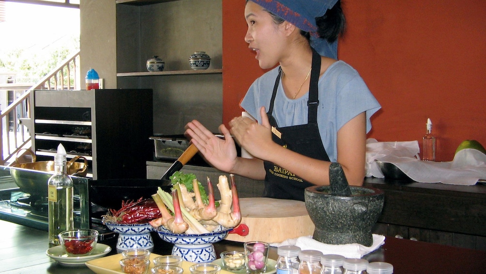 A cooking instructor teaching a class in Bangkok