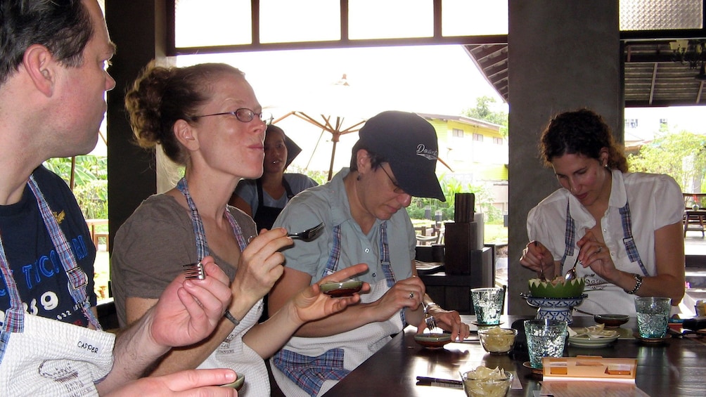 Students trying food at a cooking class in bangkok