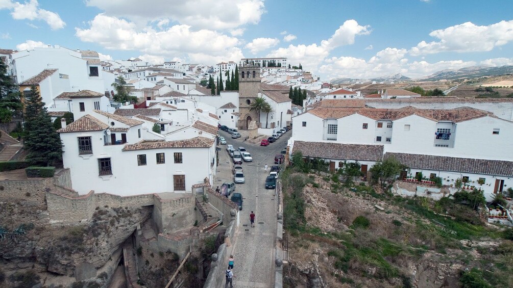 people crossing the Puente Nuevo Bridge in the city of Ronda