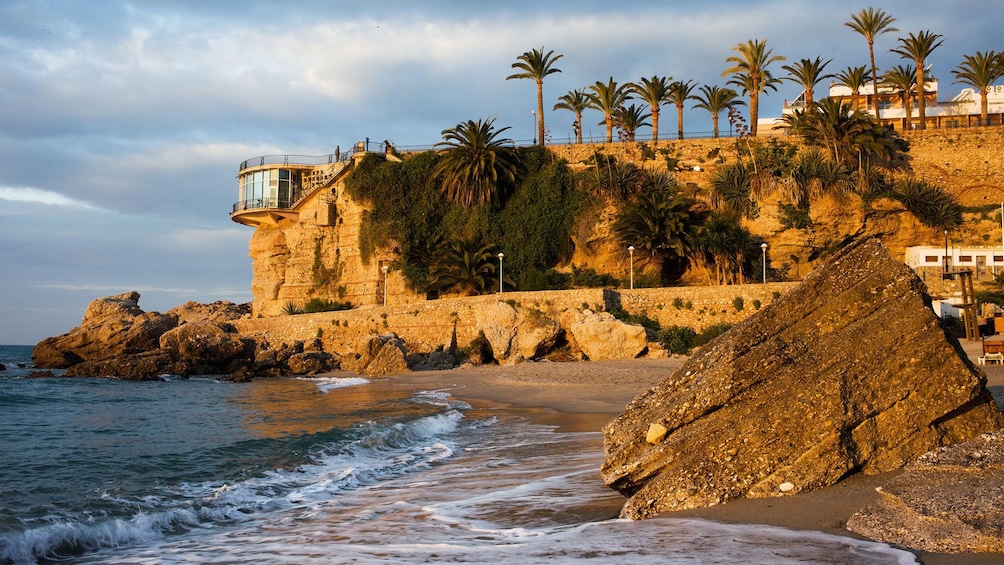 boulder sitting on the beach in Nerja