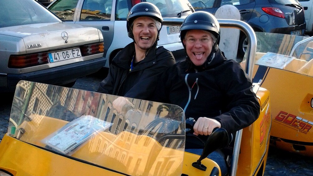 men in Go Car exploring the city in Lisbon
