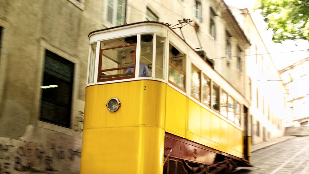 city tram moving down a steep hill in Lisbon