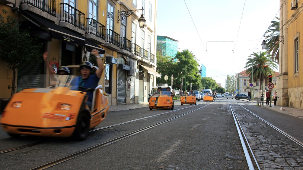 men cheering from Go Car on the streets in Lisbon