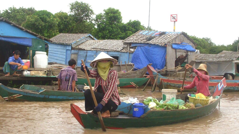 Men and women sailing on the waters of Tonlé Sap