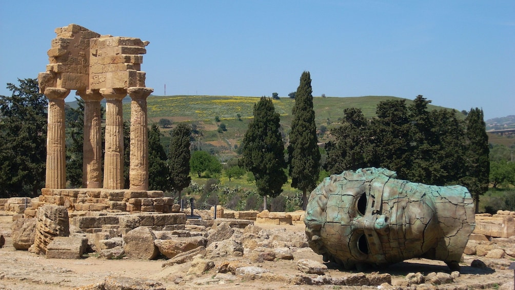 head of a statue among the temple ruins in Sicily