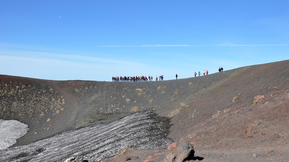 group looking at a big crater of Mount Etna in Sicily
