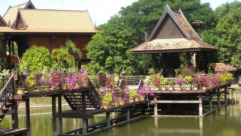 Gorgeous view of some wooden tree house above the waters on the countryside of Siem Reap