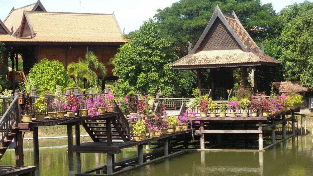 Gorgeous view of some wooden tree house above the waters on the countryside of Siem Reap 