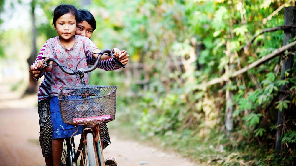 Two siblings enjoying a scenic bike tour of gorgeous Siem Reap's countryside