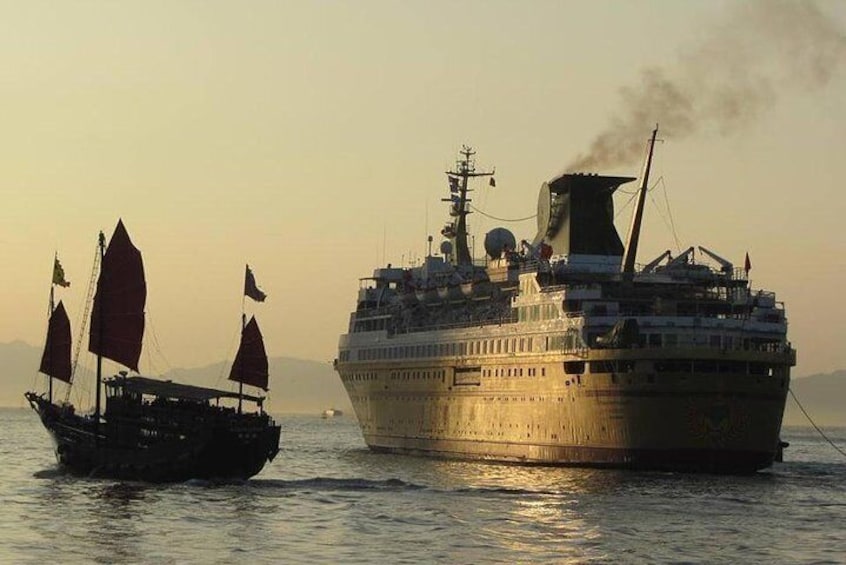 Junk boat and cruiser ship