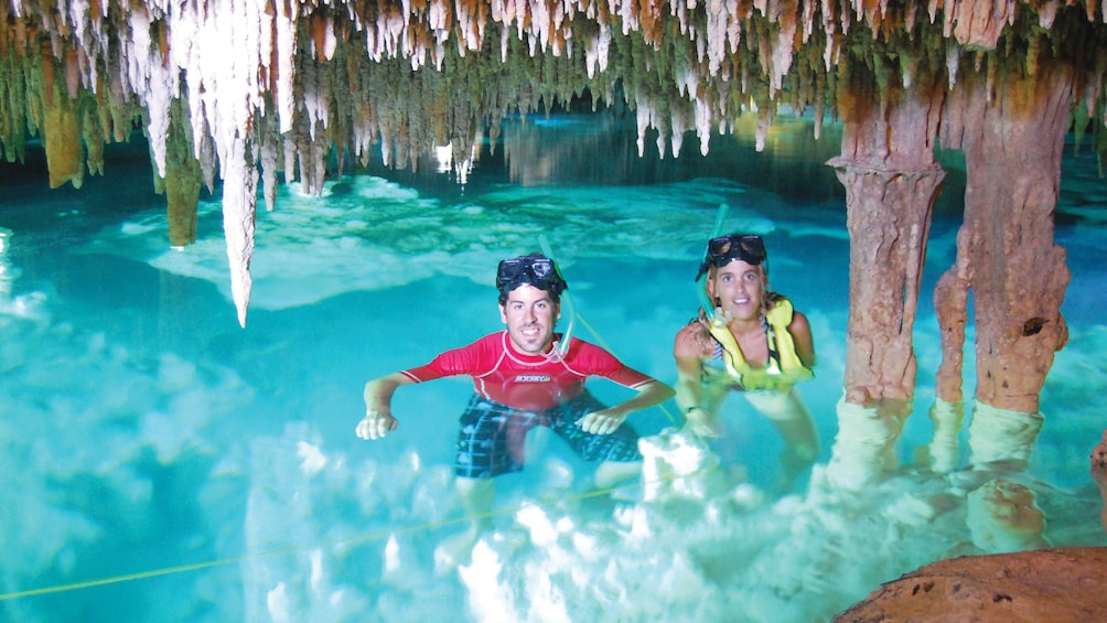Snorkelers in an cavernous pool in Cancun
